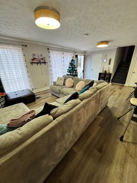 living room with hardwood / wood-style floors and a textured ceiling