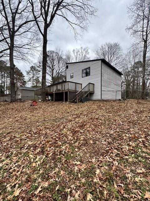 rear view of property with a wooden deck