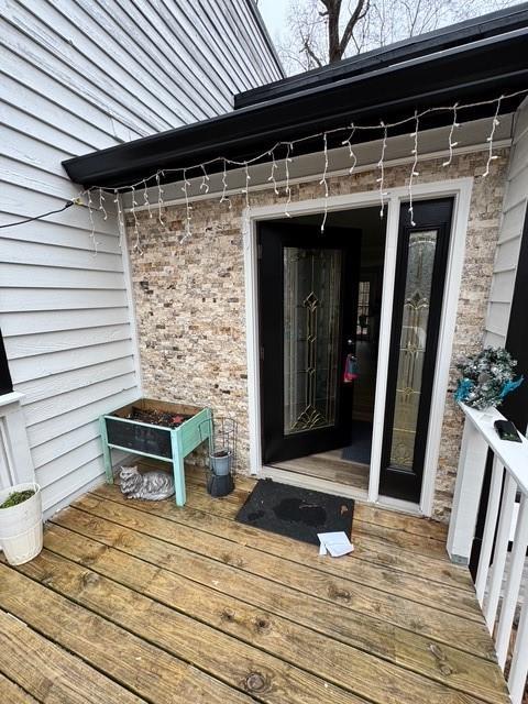 entrance to property featuring a deck