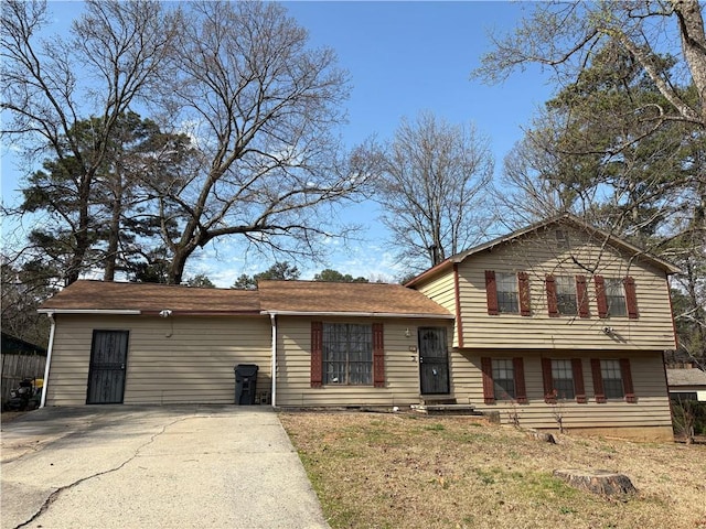 split level home with a front lawn and driveway