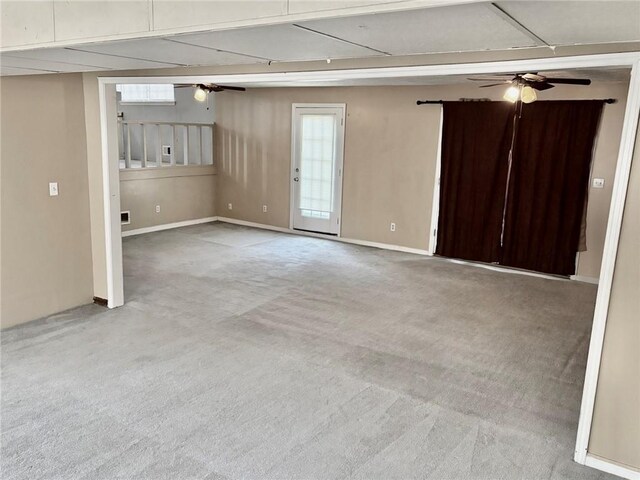 spare room featuring ceiling fan, light colored carpet, and a textured ceiling