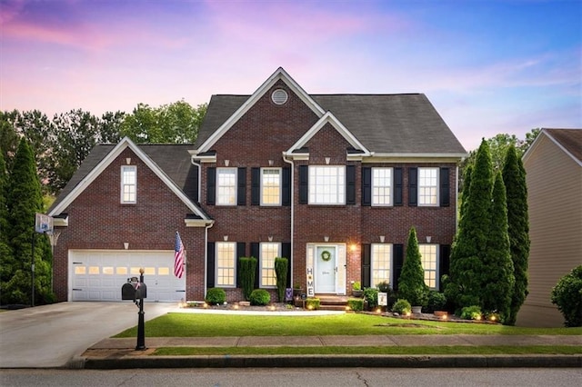242 Sandhurst Ct, Suwanee, GA 30024 - view of front of home with driveway, brick siding, a yard, and an attached garage