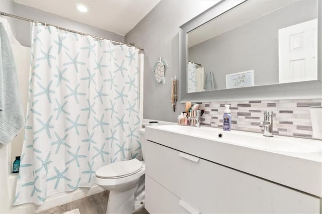 242 Sandhurst Ct, Suwanee, GA 30024 - bathroom with vanity, toilet, decorative backsplash, wood finished floors, and recessed lighting