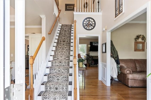 242 Sandhurst Ct, Suwanee, GA 30024 - stairs with wood finished floors, a high ceiling, and ornamental molding