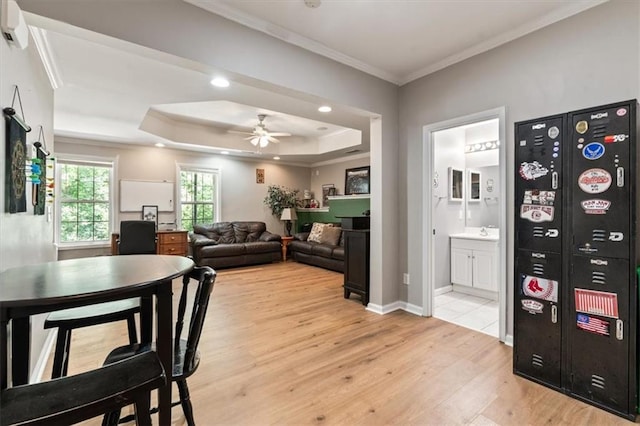 242 Sandhurst Ct, Suwanee, GA 30024 - living room featuring light wood finished floors, crown molding, a raised ceiling, a ceiling fan, and recessed lighting
