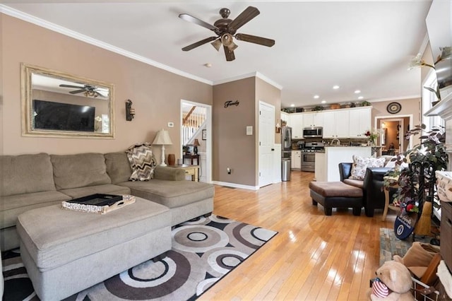 242 Sandhurst Ct, Suwanee, GA 30024 - living room with a ceiling fan, light wood finished floors, crown molding, stairs, and recessed lighting