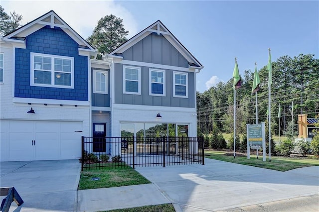 2688 NE Almand Ln, Conyers, GA 30013 - view of front of house with board and batten siding, concrete driveway, fence, brick siding, and a garage