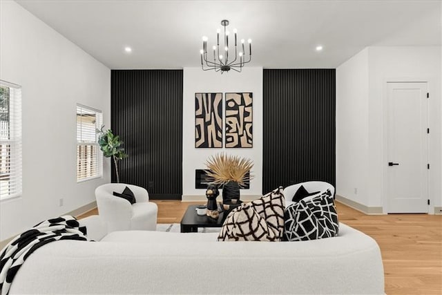 living room with hardwood / wood-style floors and an inviting chandelier