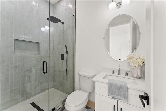 bathroom with vanity, an enclosed shower, and toilet