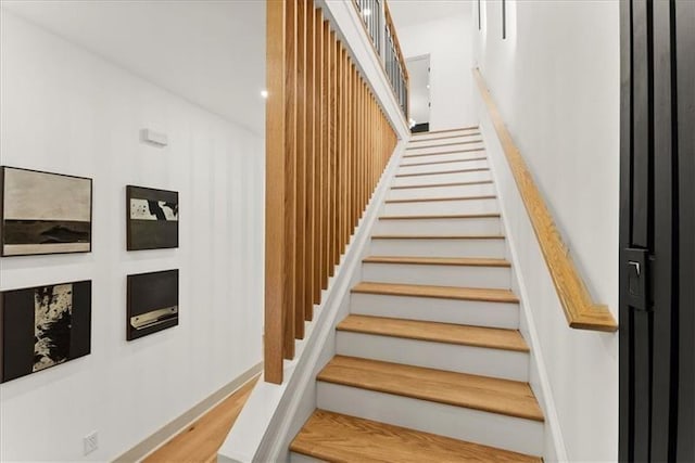 stairway with hardwood / wood-style flooring