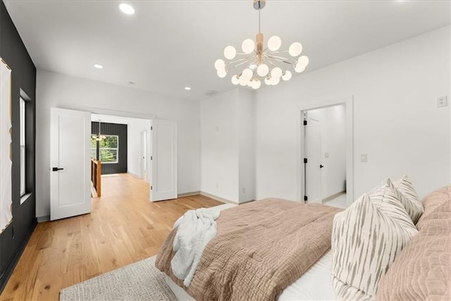 bedroom featuring a chandelier and light hardwood / wood-style flooring