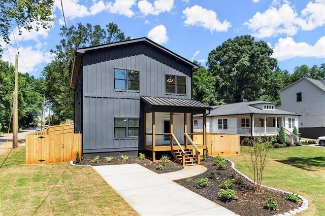 modern farmhouse style home featuring a porch and a front yard