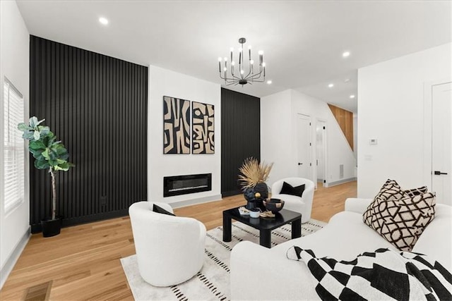 living room featuring light hardwood / wood-style floors and an inviting chandelier