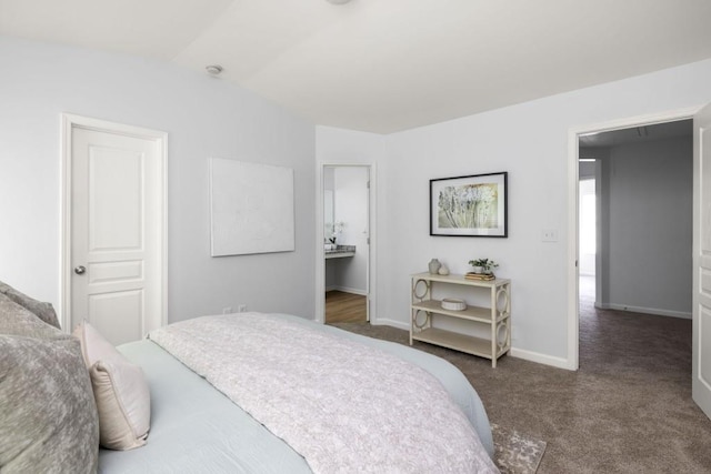 bedroom with carpet flooring, lofted ceiling, and baseboards