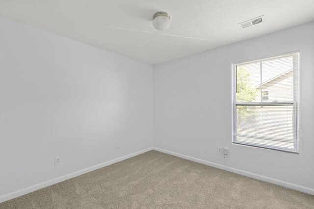 carpeted empty room with baseboards
