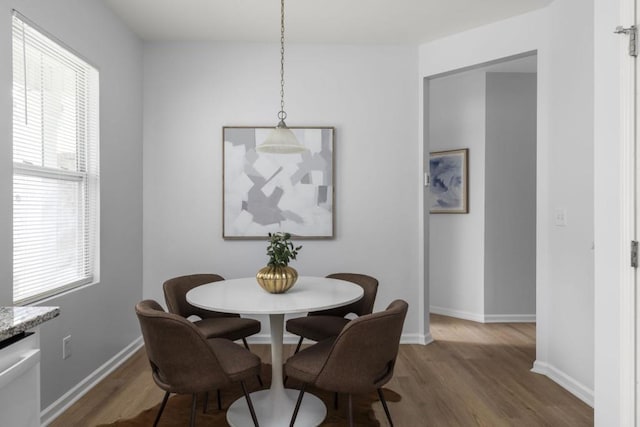 dining area featuring wood finished floors and baseboards