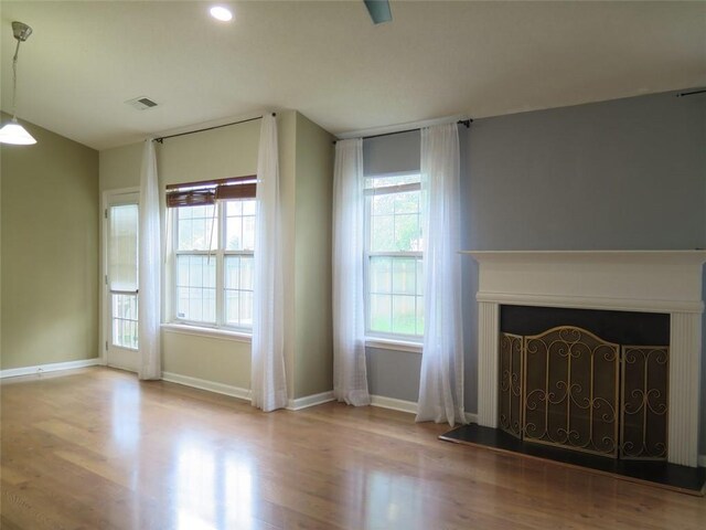 4517 Baker Grove Rd NW, Acworth, GA 30101 - unfurnished living room with baseboards, wood finished floors, and a fireplace with raised hearth