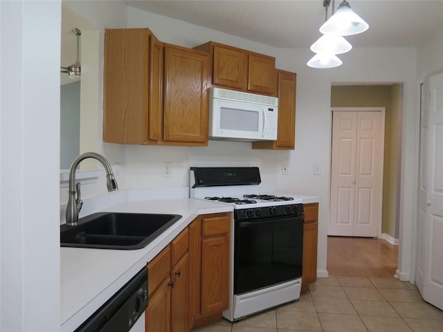 4517 Baker Grove Rd NW, Acworth, GA 30101 - kitchen featuring white appliances, a sink, light countertops, brown cabinets, and light tile patterned floors