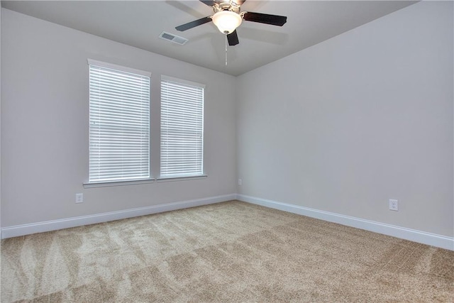 unfurnished room featuring light colored carpet and ceiling fan