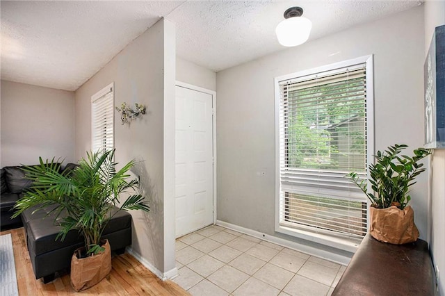 8740 Roswell Rd Unit 2G, Atlanta, GA 30350 - entryway featuring baseboards and a textured ceiling