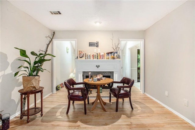 8740 Roswell Rd Unit 2G, Atlanta, GA 30350 - dining area with a fireplace, light wood-type flooring, and baseboards