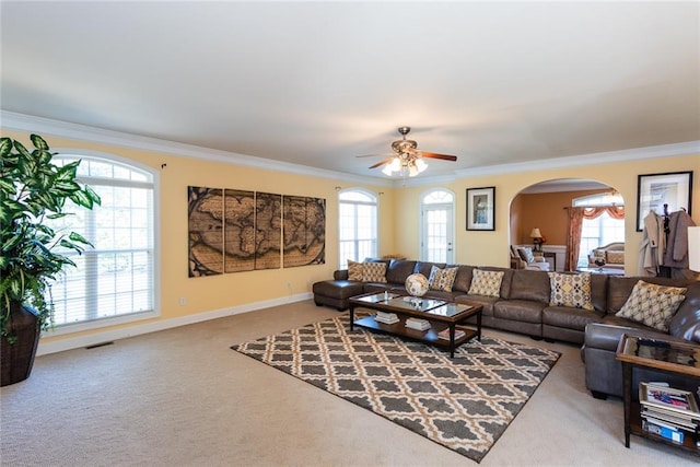 carpeted living room featuring crown molding and a wealth of natural light