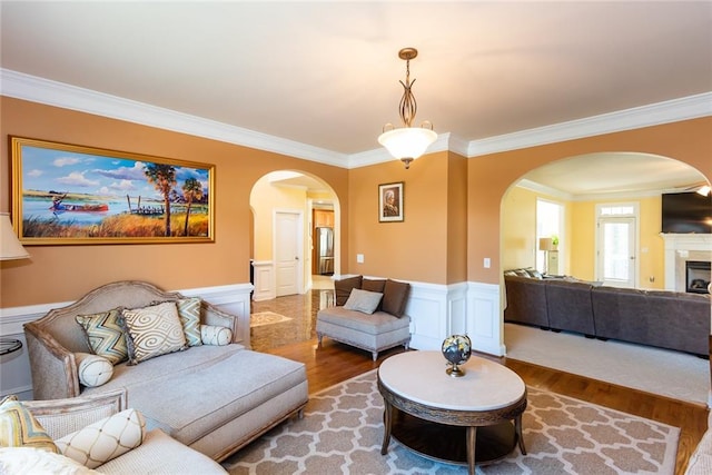 living room with crown molding and hardwood / wood-style floors