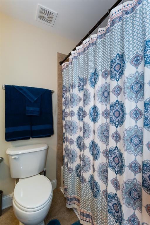 bathroom with toilet and tile patterned flooring