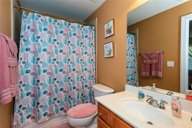 bathroom featuring toilet and vanity