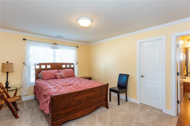 bedroom featuring ornamental molding, ensuite bath, and light colored carpet