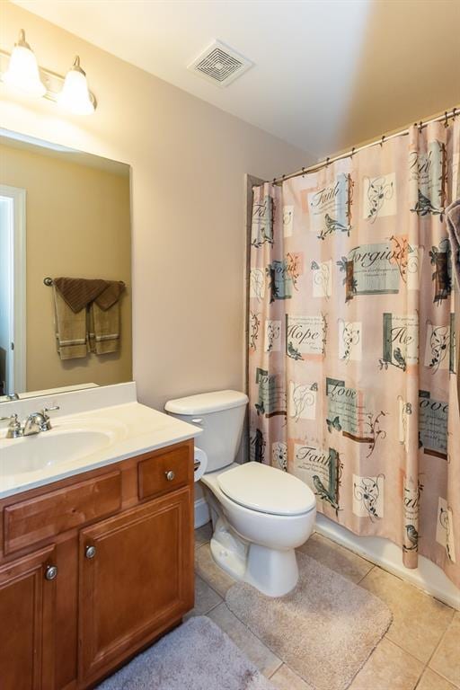 bathroom featuring vanity, toilet, and tile patterned floors