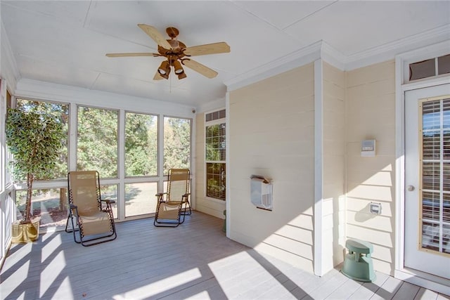 sunroom featuring ceiling fan