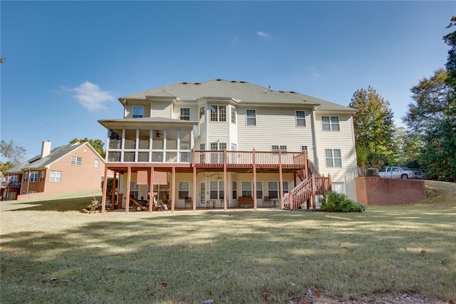 back of property with a yard, a deck, and a patio area