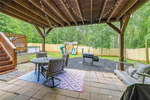 253 Grindstone Creek Dr, Clarkesville, GA 30523 - fenced backyard featuring a patio area, a playground, outdoor dining space, and a view of trees