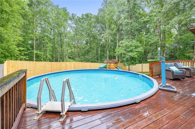 253 Grindstone Creek Dr, Clarkesville, GA 30523 - view of pool featuring a fenced backyard, a deck, outdoor lounge area, a playground, and a view of trees