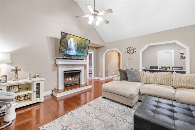 253 Grindstone Creek Dr, Clarkesville, GA 30523 - living room with a ceiling fan, wood finished floors, a lit fireplace, high vaulted ceiling, and baseboards