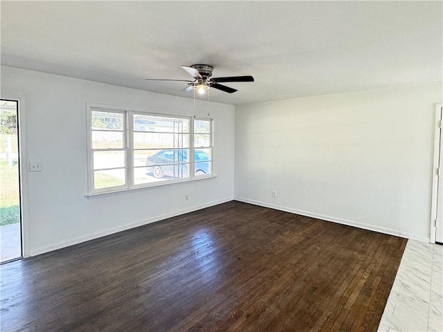 unfurnished room with ceiling fan, dark wood-type flooring, and a wealth of natural light