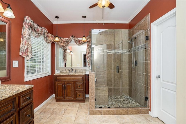 bathroom with vanity, crown molding, ceiling fan, and a shower stall