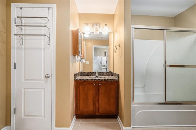 bathroom featuring baseboards, tile patterned flooring, and vanity
