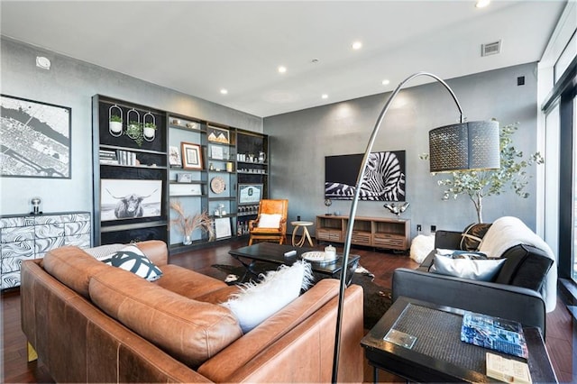 living area with recessed lighting, visible vents, and wood finished floors