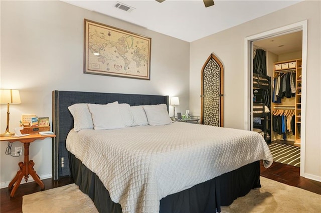 bedroom featuring wood finished floors, a closet, a walk in closet, and visible vents