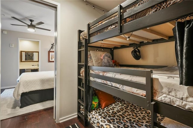 bedroom with baseboards and wood finished floors