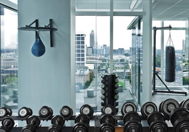 interior space with a wall of windows and a city view