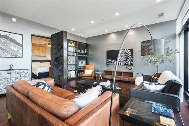 living area featuring recessed lighting, visible vents, and wood finished floors