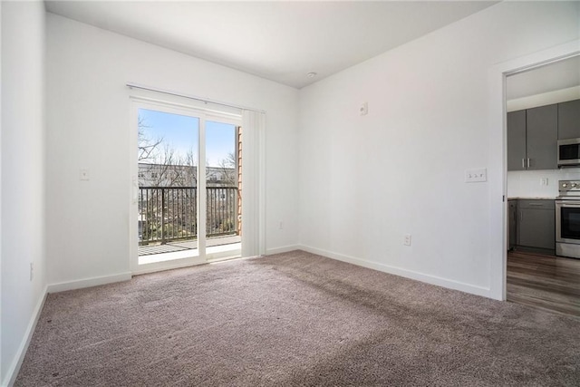 carpeted spare room with baseboards