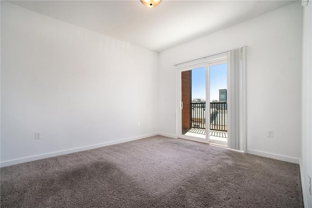 carpeted empty room with baseboards