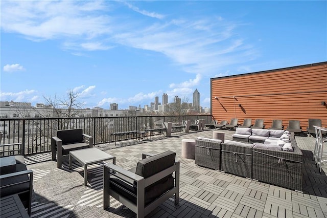 view of patio / terrace featuring an outdoor hangout area and a city view