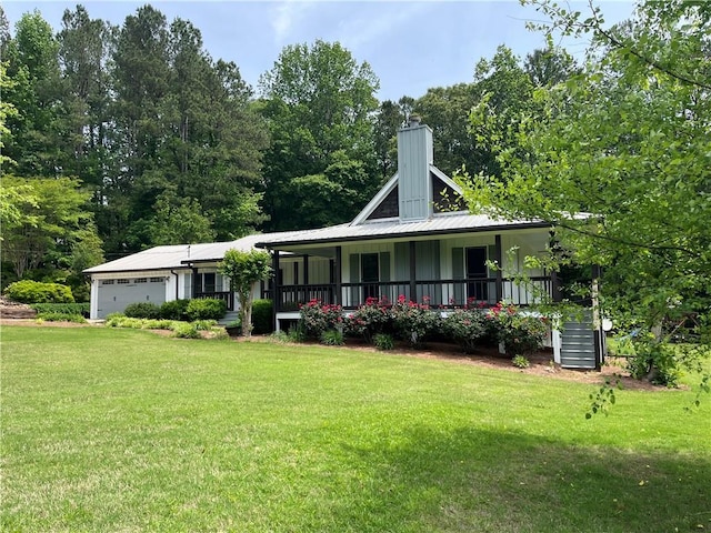 2057 High Shoals Rd, Dallas, GA 30132 - farmhouse-style home with a porch, a front lawn, an attached garage, and a chimney