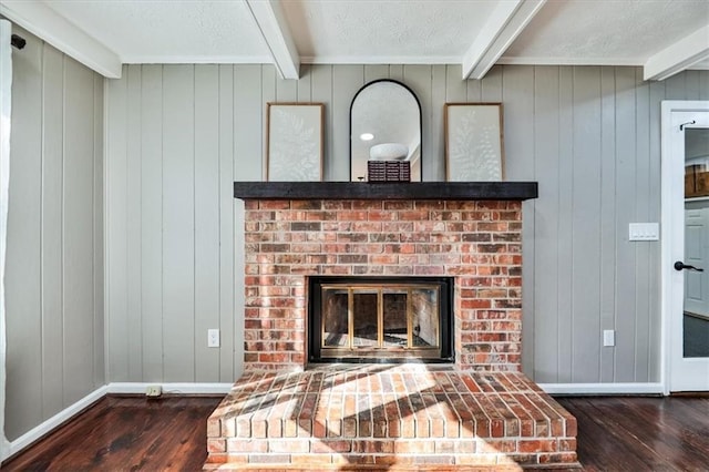 2057 High Shoals Rd, Dallas, GA 30132 - detailed view of wood finished floors, beamed ceiling, a brick fireplace, and wood walls