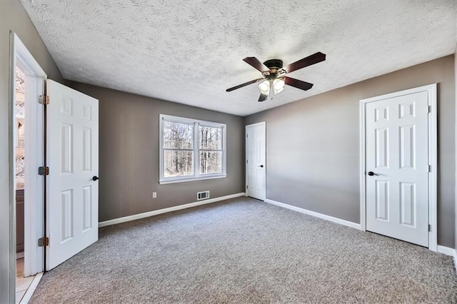 2057 High Shoals Rd, Dallas, GA 30132 - unfurnished bedroom featuring carpet, a textured ceiling, and ceiling fan